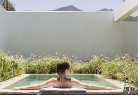 Woman soaking in her heated plunge pool.