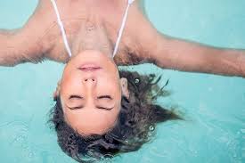 Woman relaxing in her plunge pool.
