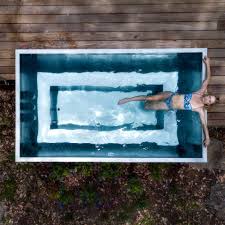 Woman soaking in a Stoked Stainless Plunge Spa Pool.
