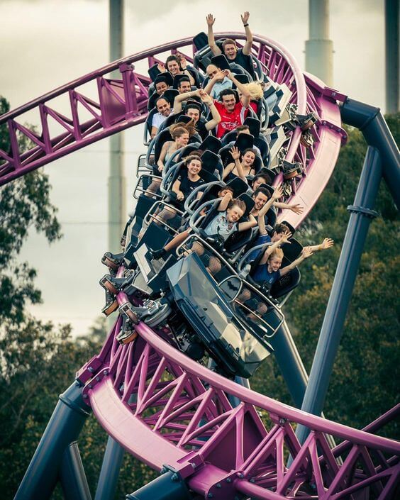 People thrilled while riding a roller coaster at a Gold Coast theme park.