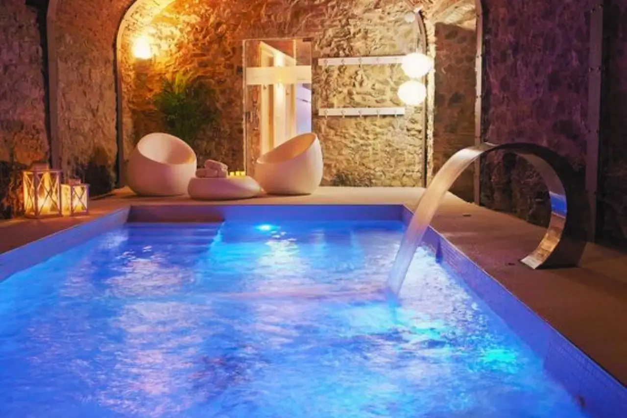 Indoor pool with waterfall installed.