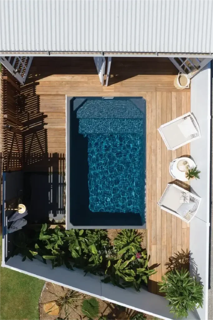 Plungie Studio pool with elegant poolside furniture.