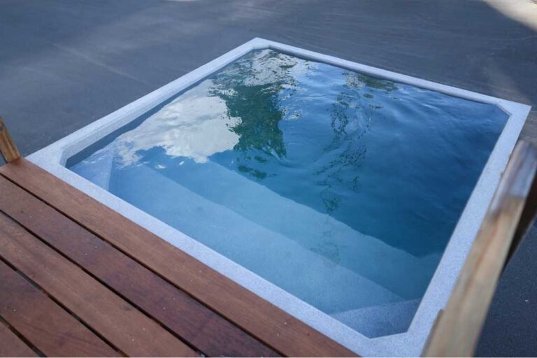 Plungie Quad, a 2.2m x 2.2m square precast concrete plunge pool filled with clear water, adjacent to a timber deck.