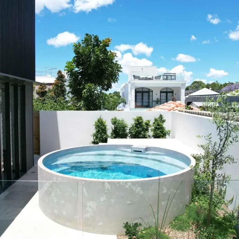 Above ground plunge pool with glass fencing and landscaped backyard in Miami Gold Coast