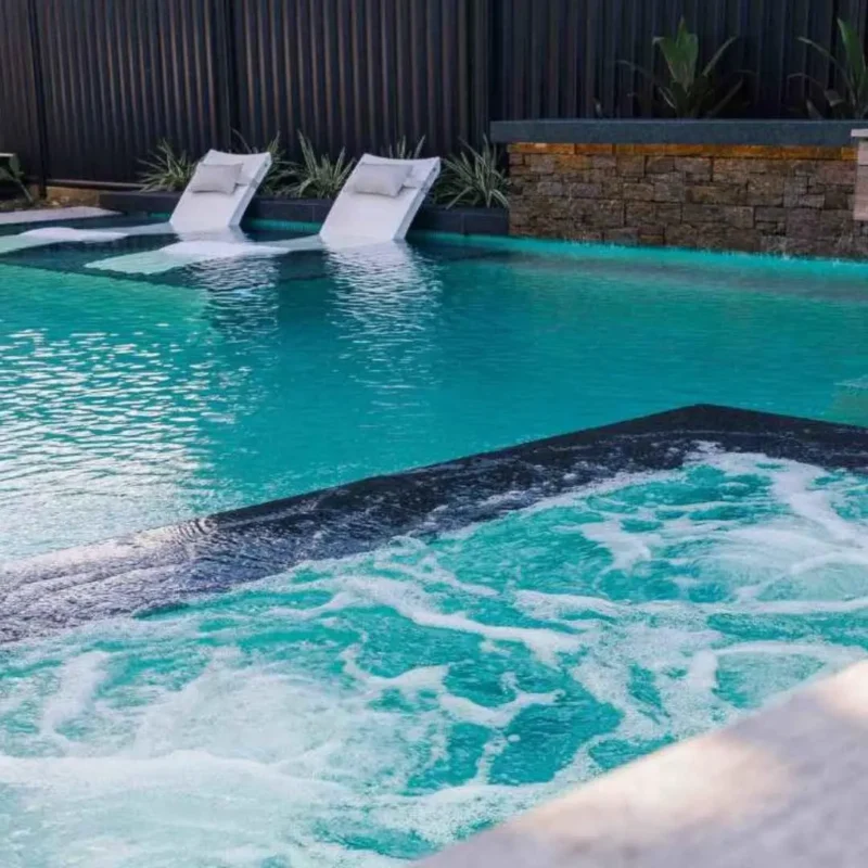 Luxury swimming pool with spa jets and in-water loungers in Carrara Gold Coast
