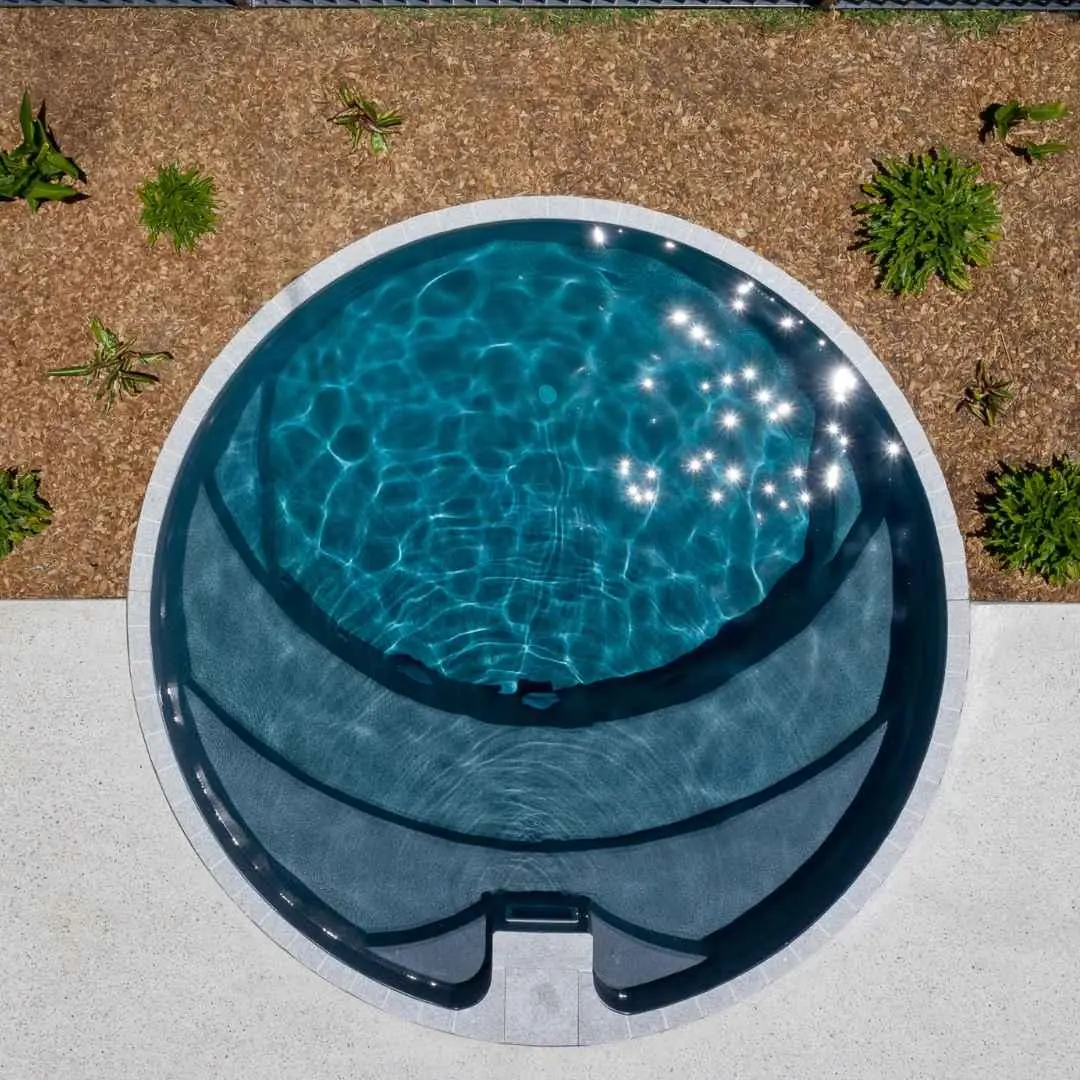 Round precast plunge pool with internal seating viewed from above in Coolangatta Gold Coast