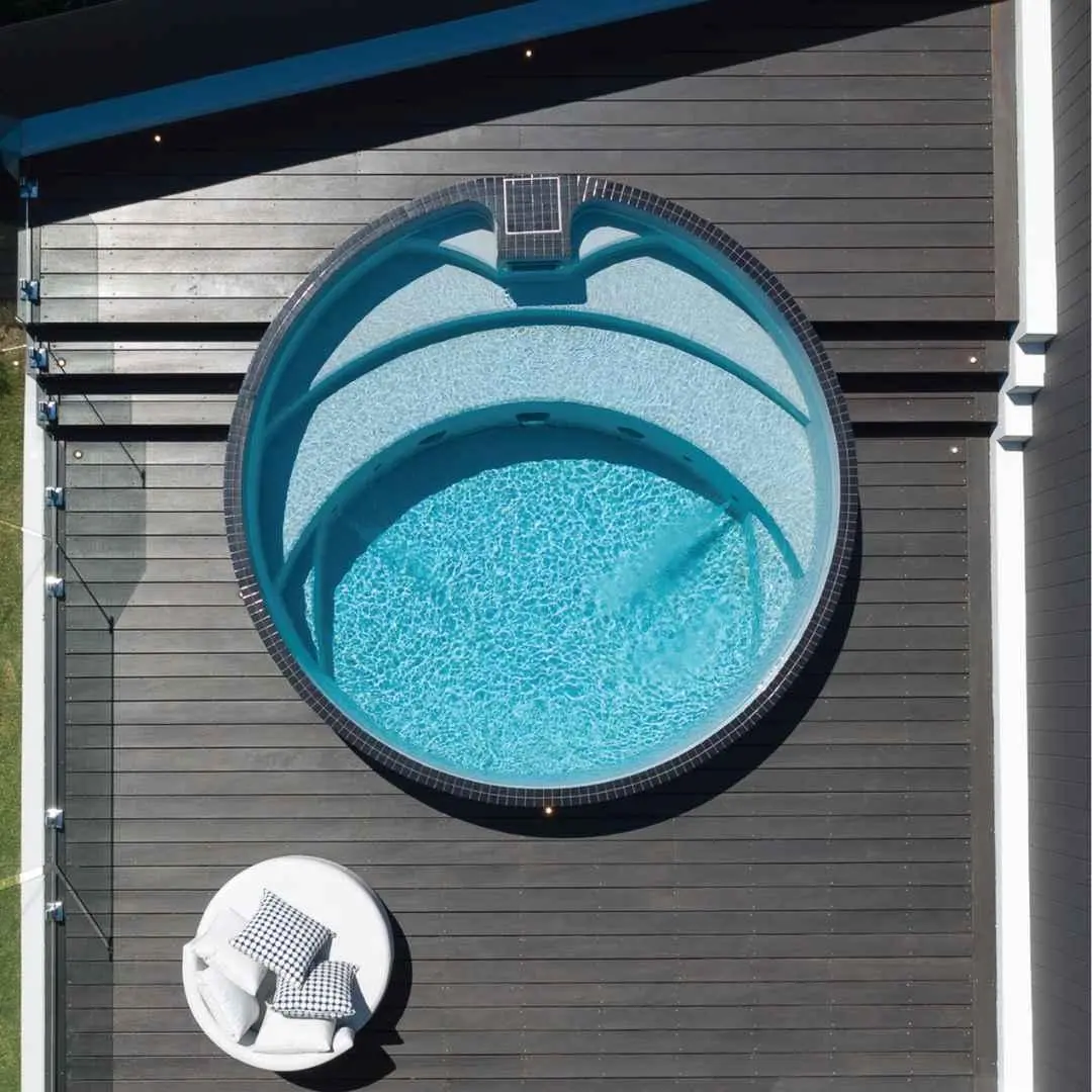 Round precast plunge pool with internal seating viewed from above in Miami Gold Coast