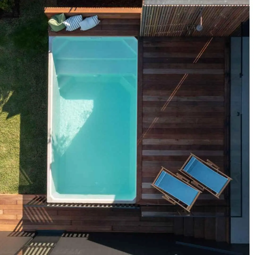Rectangular precast plunge pool with timber decking and lounge chairs in Varsity Lakes Gold Coast